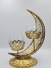 Load image into Gallery viewer, This Ramadan light up your home with this beautiful and elegant candle holder. The metal holder is in the shape of the Crescent Moon and two small candle holder sits in the middle.
